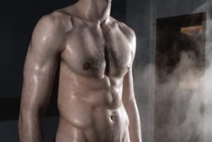 Masculine men in locker room embracing - queer artistic scene from FEEL by The Concrete Shamans