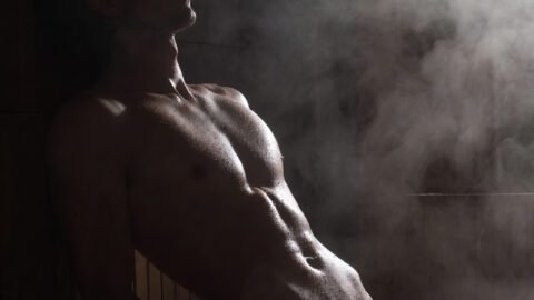 Artistic sensual music video still from FEEL by The Concrete Shamans showing intimate male connection in a locker room shower from MASC album